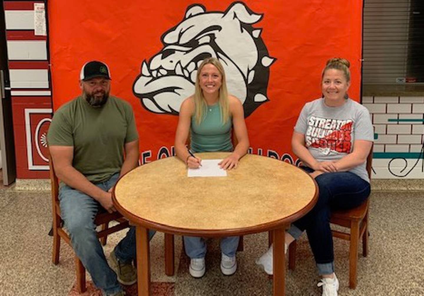 Recent Streator High School graduate Anna McMullen has committed to continue her academic career at the University of Dubuque and her soccer career at the NCAA Division III level with the Spartans. Pictured here is McMullen alongside her parents, Adam and Jen McMullen.