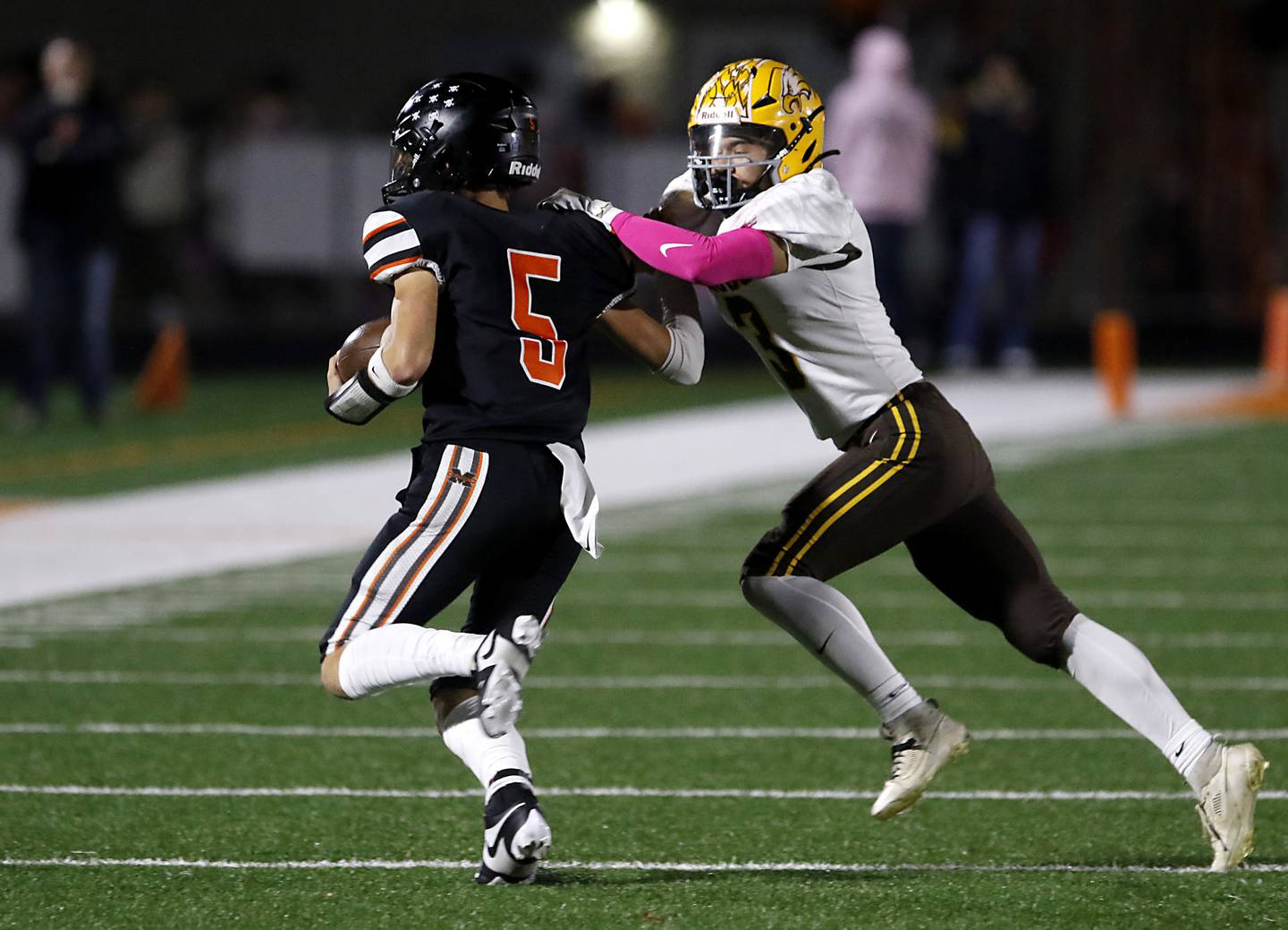 Jacobs' Owen Hoffman tries to tackle McHenry's Dayton Warren during a Fox Valley Conference football game on Friday, Oct. 18, 2024, at McCracken Field in McHenry.