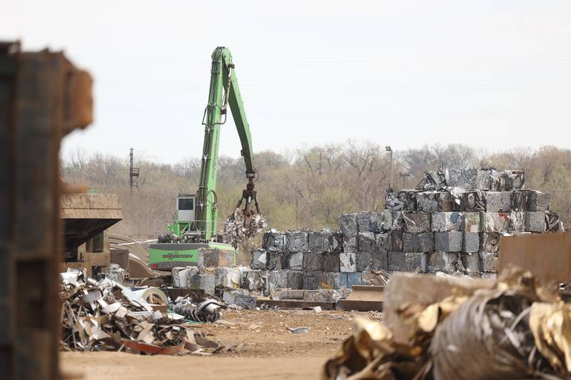 A crawler crane moves piles of metal scrap in the salvage yard of BL Duke on Friday, April 14, 2023 in Joliet.