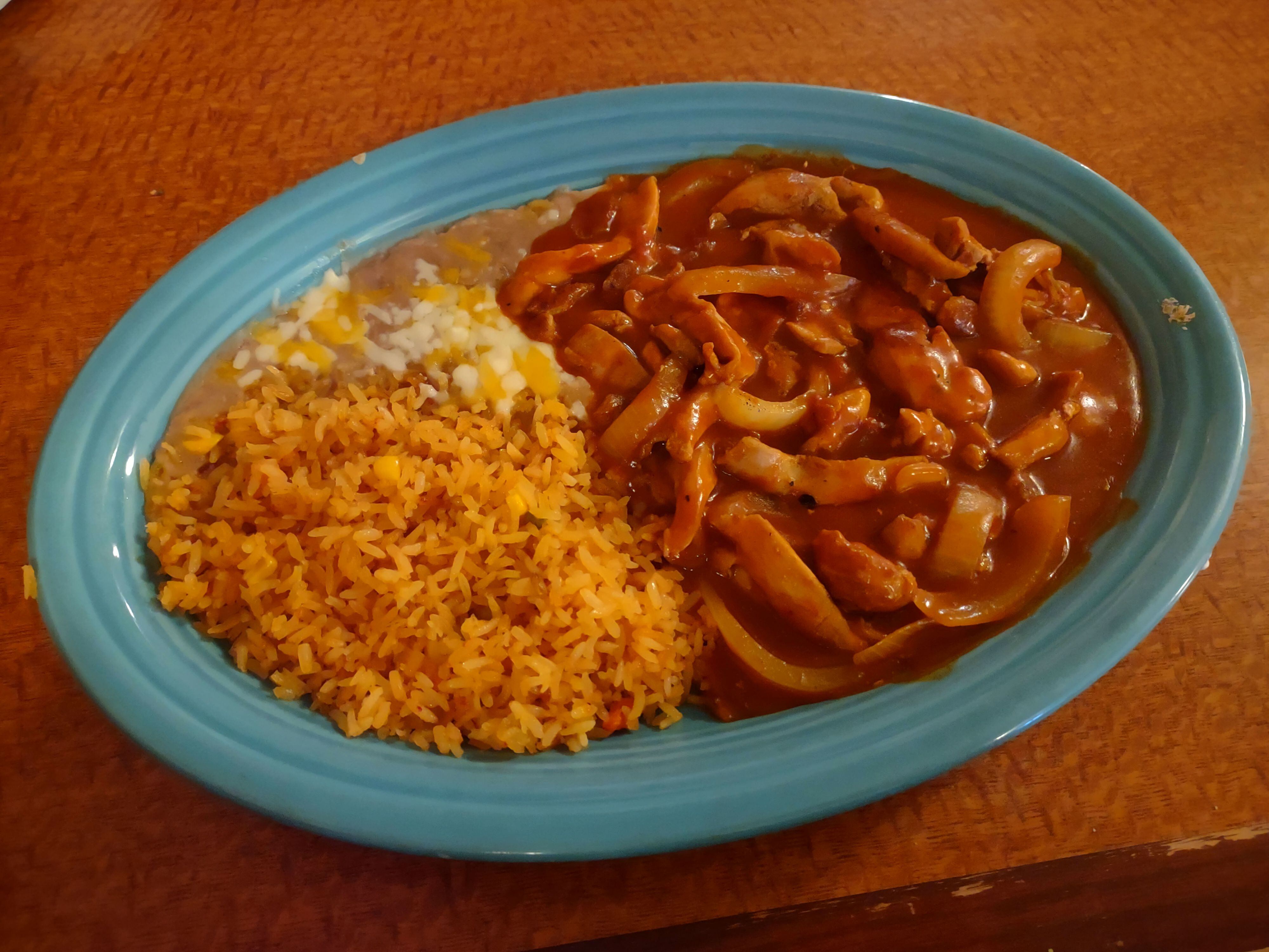 The chili Colorado with chicken at Mr. Salsa's is served in red sauce with onions and a side of rice.