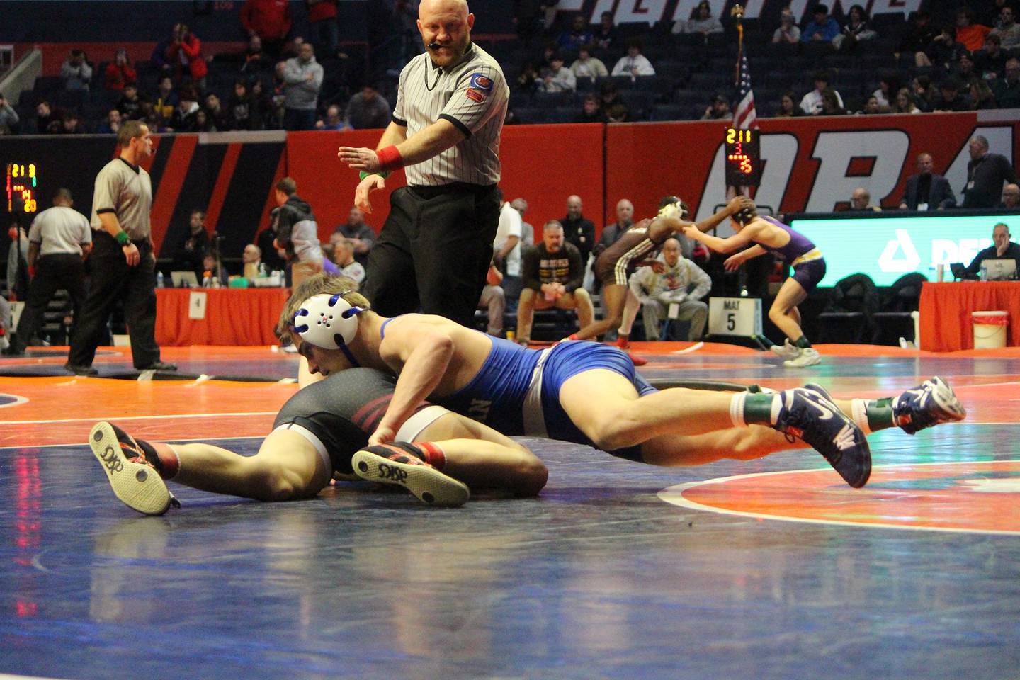 Newman's Brady Grennan controls his opponent during a 126-pound quarterfinal bout at the IHSA Individual State Finals on Thursday, Feb. 16, 2023 at State Farm Center in Champaign.