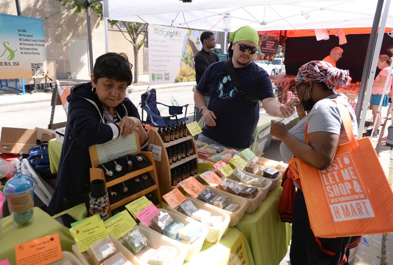 Kenneth DeRivera of LaGrange Highlands has Toni Hopkins of LaGrange Highlands smell one of the soaps sold by Island Soapies owner Zora Penafield during the LaGrange Farmers Market Thursday June 7, 2024.