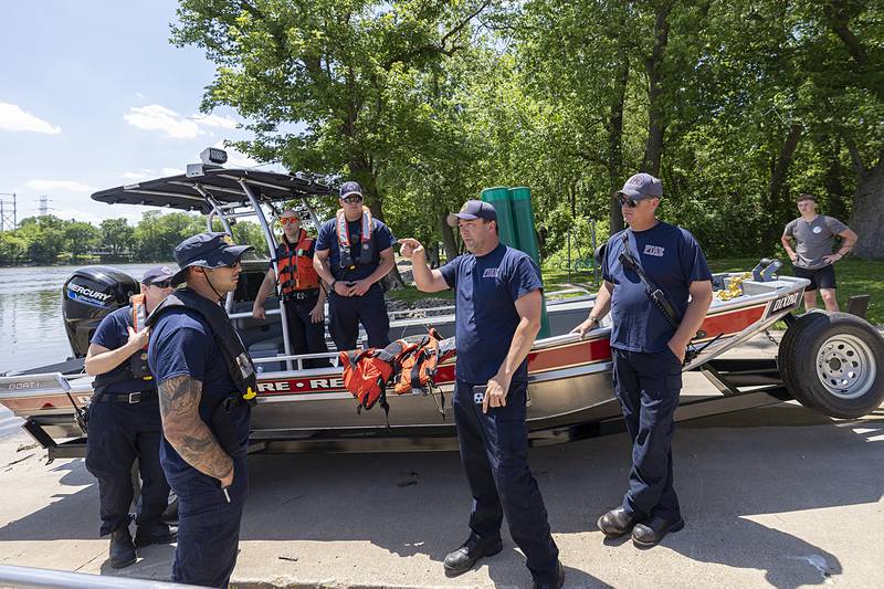 Dixon Rural chief Dustin Dahlstrom (center) discusses the plan to drop 12 buoys from downtown Dixon to “as far as we can go” downstream Thursday, May 23, 2024.