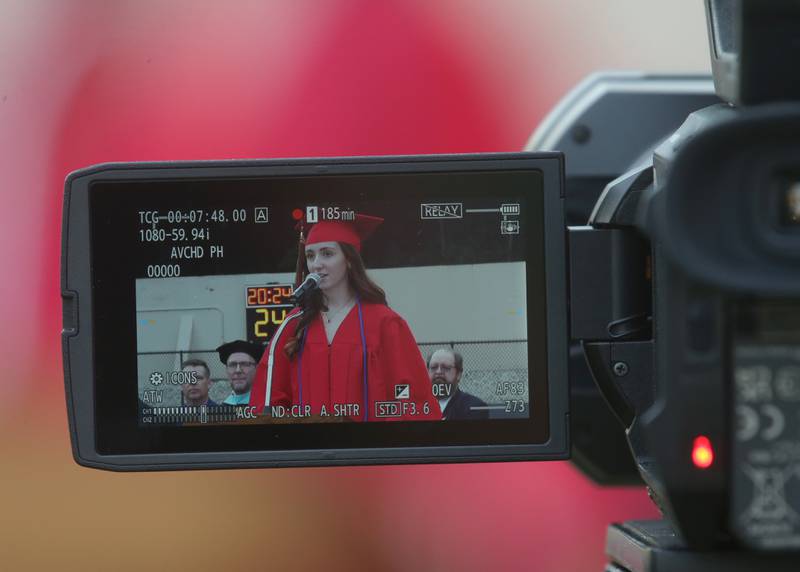 Looking through a video camera, La Salle-Peru Township High School valedictorian Faith Arkins delivers a speech during the 126th annual commencement graduation ceremony on Thursday, May 16, 2024 in Howard Fellows Stadium.