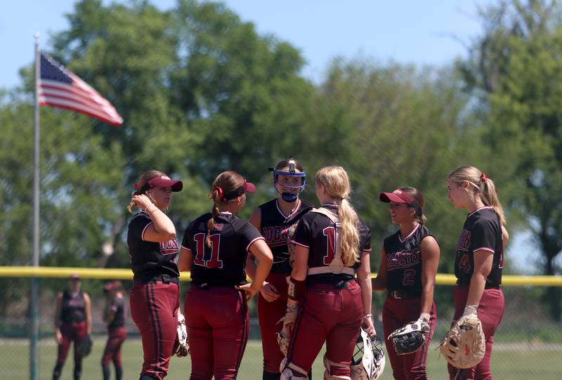 Richmond-Burton’s Rockets regroup after giving up a home run to North Boone during Class 2A softball sectional final action at Marengo Saturday.