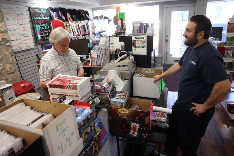 Joe Rudziewicz rings up William Torres, a regular customer, on new release Wednesday at Amazing Fantasy Comics on Wednesday, May 1, 2024 in downtown Lockport.