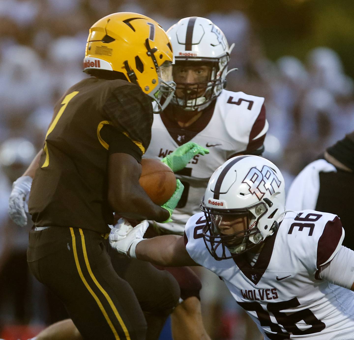 Prairie Ridge's Andrew Koeppen and Giovanni Creatore (right) tackle Jacobs' Tyvon Boddie during a Fox Valley Conference football game on Friday, Aug 30, 2024, at Jacobs High School in Algonquin.