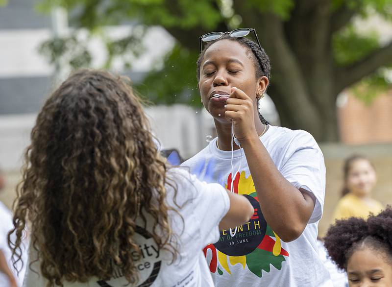 Joselyn Green blows bubbles with her friends Saturday, June 22, 2024 at a Juneteenth celebration in Sterling. Green is part of the Black Student Union at Sterling High School.