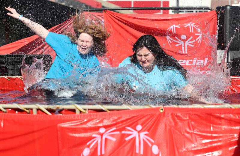 Members of the Sigma Lambda Sigma sorority jump into the water on a cold and windy Saturday, Feb 17, 2024, during the Huskie Stadium Polar Plunge at Northern Illinois University in DeKalb. The Polar Plunge is the signature fundraiser for Special Olympics Illinois.