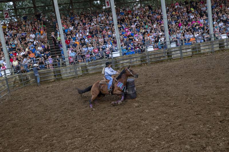 Sherri Wright heads for the straightaway in the Rice Bull Riding and Barrel Racing event Thursday, August 11, 2023 at the Carroll County fair.