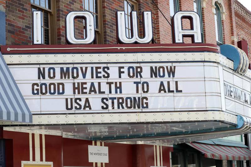 The marquee for the Iowa Theater, closed in response to the coronavirus outbreak, is seen on John Wayne Drive, Wednesday, April 1, 2020, in Winterset, Iowa. The new coronavirus causes mild or moderate symptoms for most people, but for some, especially older adults and people with existing health problems, it can cause more severe illness or death. (AP Photo/Charlie Neibergall)