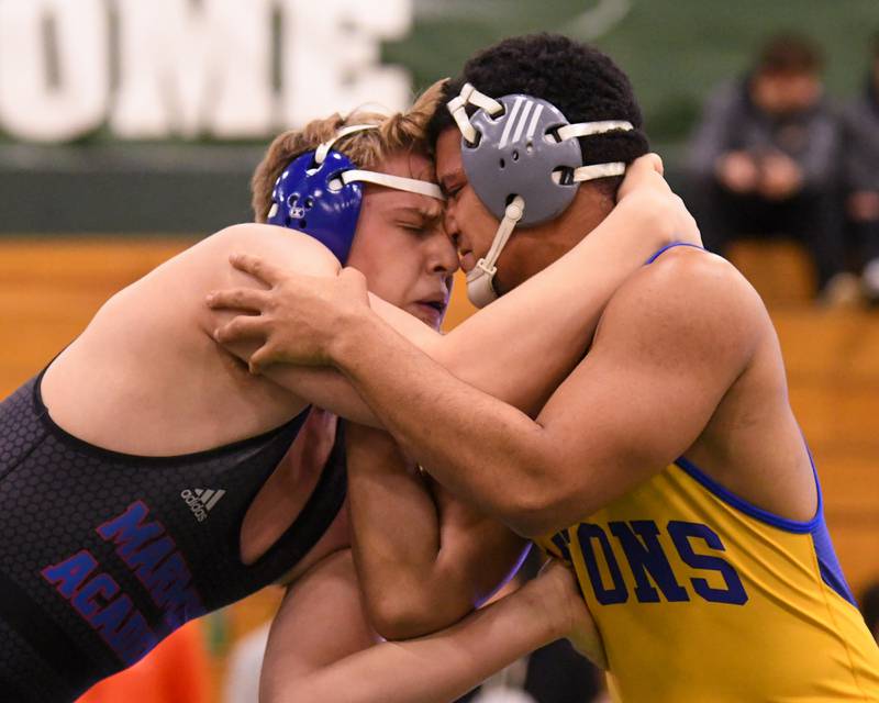 Mateusz Nycz of Marmion Academy, left, wins the regional title match over Lyons Township wrestler Sam Costello in the 285 weight class on Saturday Feb. 3, 2024, held at Glenbard West High School.