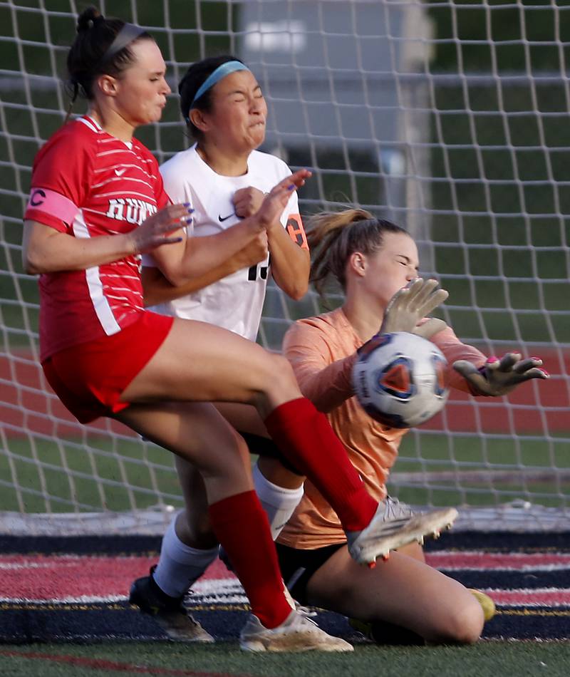 McHenry's Makenna Harvey tries to stop the shot of Huntley’s Grace Helzer (left)  as McHenry's Mara Torres (center) also defends on the play during  a Fox Valley Conference soccer match Thursday, April 13, 2023, at Huntley High School.