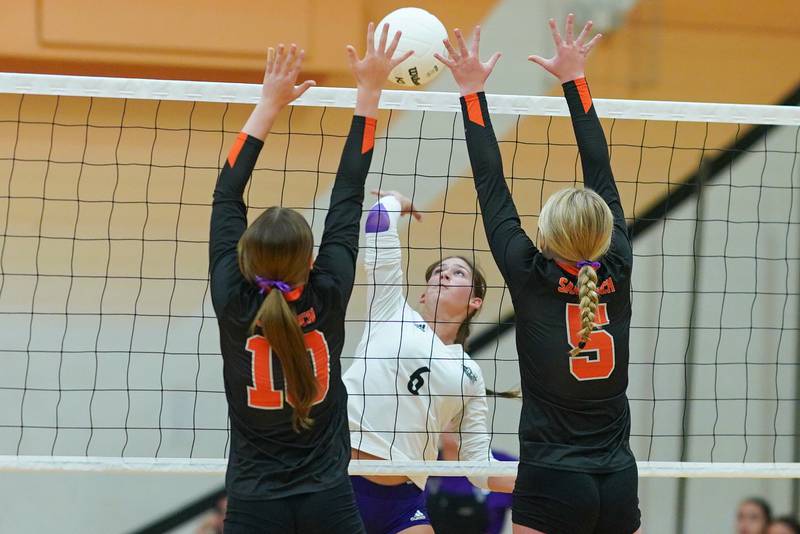 Plano’s Taylor Downs (6) goes up for a kill attempt against Sandwich’s Kayden Corneils (10) and Jessica Ramey (5) during a volleyball match at Sandwich High School on Tuesday, Sep 10, 2024.