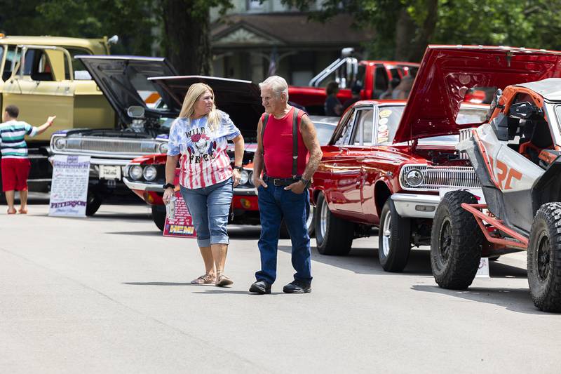 Pete Nielsen and daughter Laura Nielsen-Walls walk through the car show at John Dixon park Monday, July 3, 2023 for the annual Petunia Fest car show.