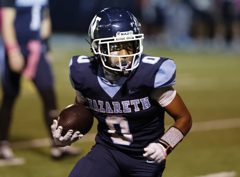 Nazareth's Edward McClain Jr. (0) runs the ball during the varsity football game between Benet and Nazareth academies on Friday, Oct. 18, 2024 in La Grange Park.