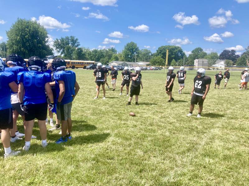 Princeton huddles up before running a play against Class 6A semifinalist Washington in Thursday's controlled practice/scrimmage at Little Siberia in Princeton on Thursday, July 18.