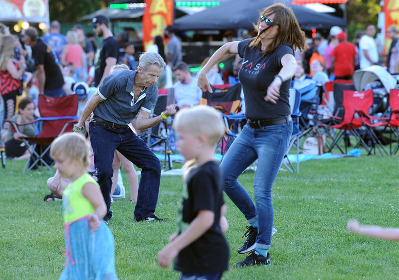 Kids and adults alike, dance to the music of the Cowboy Co Country Music Show band during the Oswegoland Park District's PrairieFest on Friday, June 14, 2024.