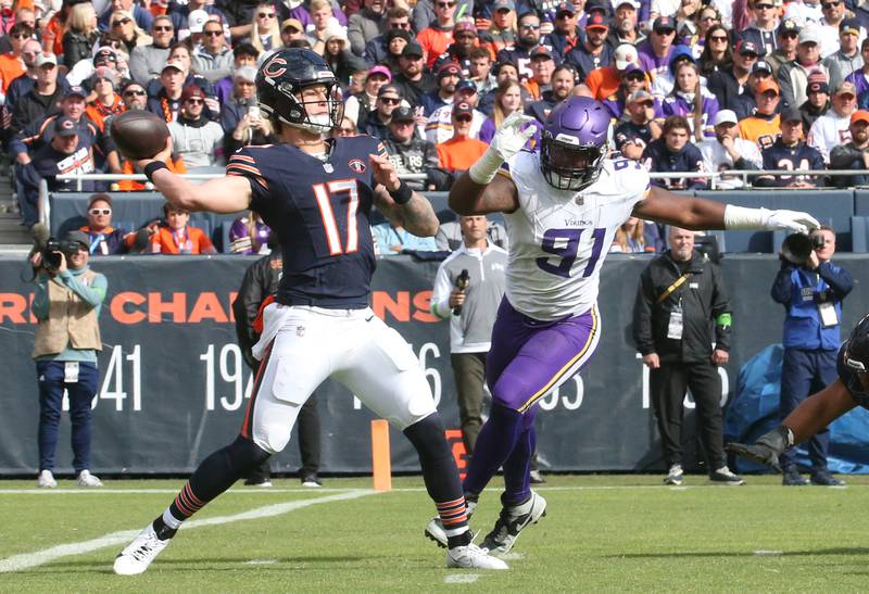 Chicago Bears quarterback Tyson Bagent throws a pass as Minnesota Vikings offensive lineman Pat Jones II approaches on Sunday, Oct. 15, 2023 at Soldier Field.