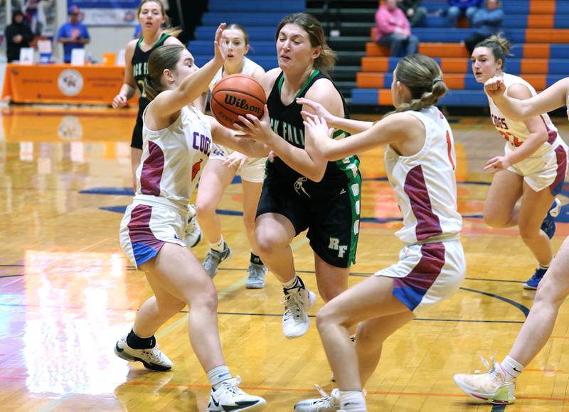 Rock Falls' Claire Bickett tries to get between Genoa-Kingston's Sydney Hansen (left) and Presley Meyer during their game Friday, Feb. 2, 2024, at Genoa-Kingston High School.