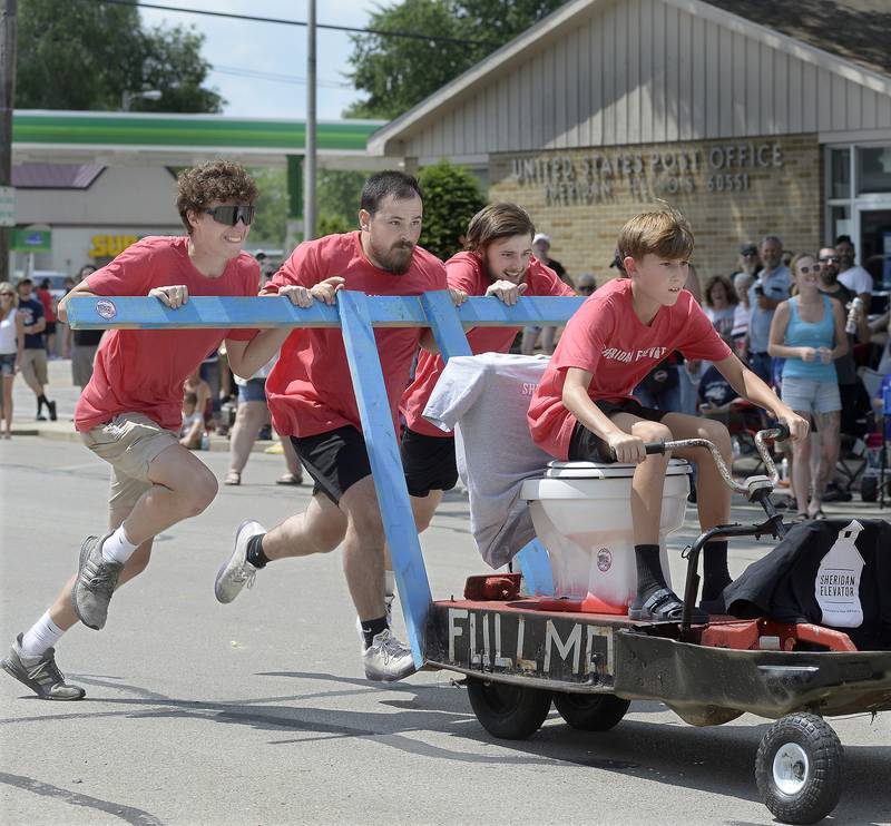 The Sheridan Elevator team pushes their entry down Si Johnson Avenue during Tuesday’s Toilet Bowl Races as part of Sheridan’s 4th of July celebration.