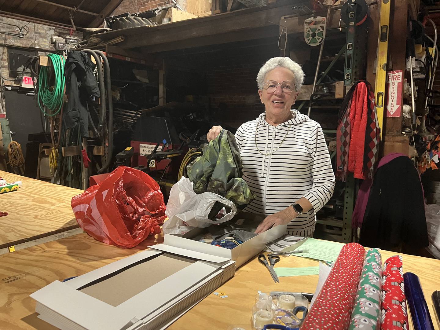 Marilyn Stromborg, a DeKalb County Circuit Clerk Office worker, wraps a present for Goodfellows of DeKalb and Sycamore during the organization's wrapping event on Dec. 13, 2023. The items will be delivered to children in need on Christmas Eve, Dec. 24, 2023.