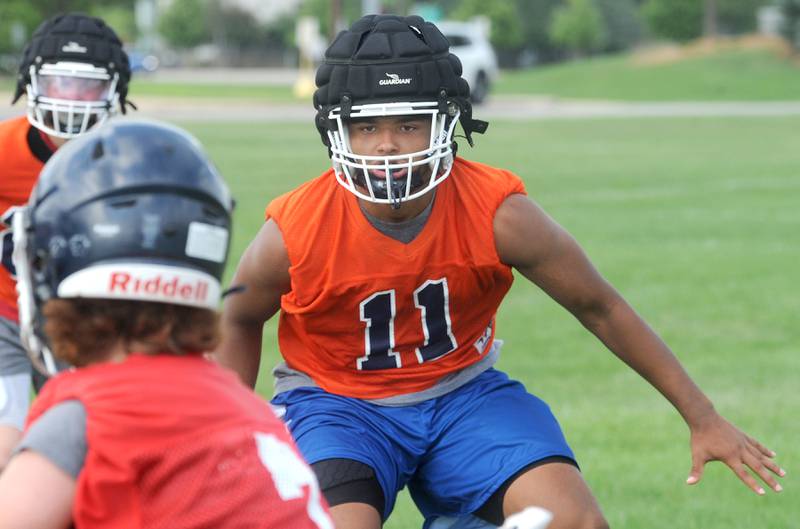 Playing on the defensive side, Oswego's Taiden Thomas shadows the quarterback during football practice at Oswego High School on Monday, Aug 7, 2023.