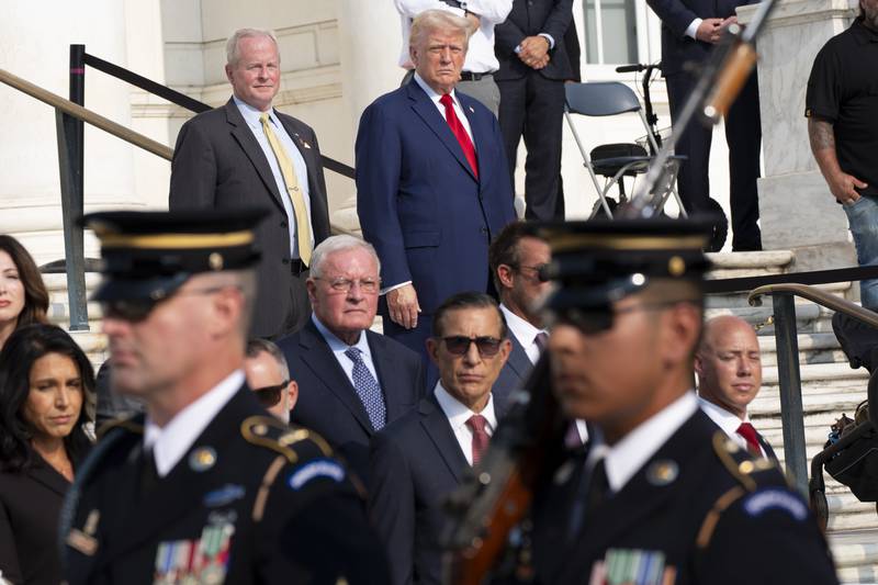 Bob Quackenbush, top left, deputy chief of staff for Arlington National Cemetery, and Republican presidential nominee former President Donald Trump watch the changing of the guard at the Tomb of the Unknown Solider at Arlington National Cemetery, Monday, Aug. 26, 2024, in Arlington, Va. (AP Photo/Alex Brandon)