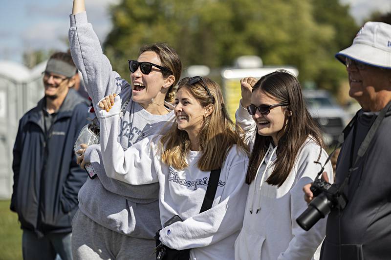 Sila Tuncel (left), Tori Davis and Lily Davis, all of Annapolis, Maryland, cheer for a chance to win a chainsaw carved prize Saturday, Oct. 7, 2023 at the Rock Falls Lumberjack show. The three were in town to support Tori and Lily’s dad Mathew Davis who is competing in the Hennepin 100 race.