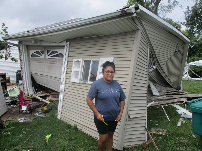 Yvette Barrera stands outside her garage, which was blown apart in the Monday night storm. A tree also fell on the Barrera house, located in the Marycrest subdivision of Joliet. July 16, 2024