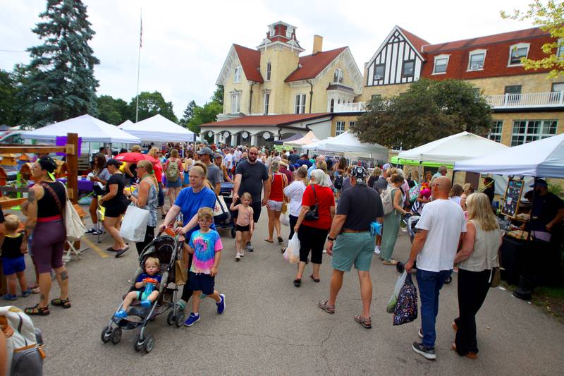 People enjoy The Dole Farmers Market in Crystal Lake Sunday.