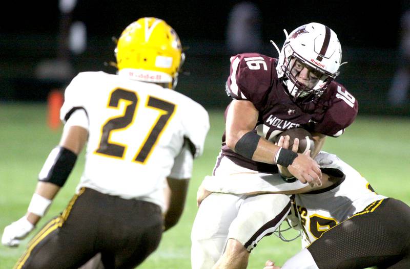 Prairie Ridge’s Dominic Creatore runs the ball as Jacobs’ Justin Gonzalez, left, moves in for a tackle in varsity football at Crystal Lake Friday night. Prairie Ridge won 6-0.