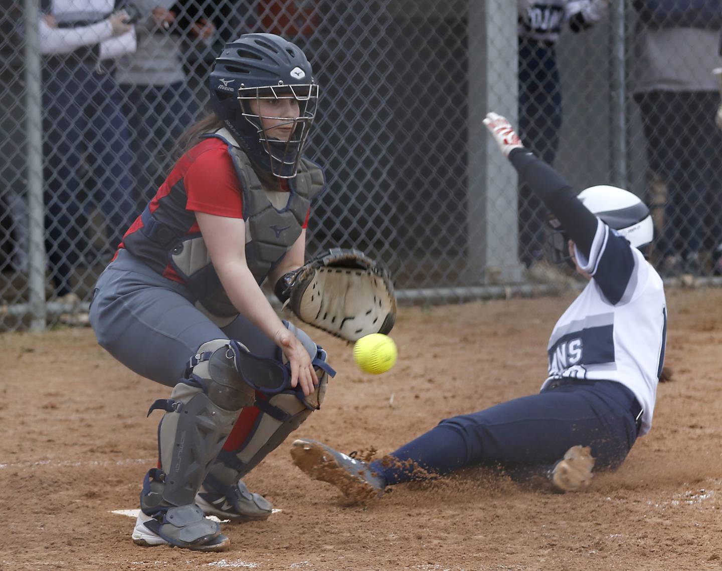 Dundee-Crown’s Faith Dierwechter tries to field the throw as Cary-Grove’s Mia Olson scores a run during a Fox Valley Conference softball game Monday, April 4, 2022, between Cary-Grove and Dundee-Crown at Cary-Grove High School.