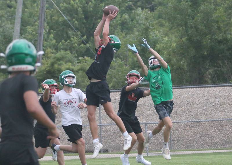 L-P's Mikey Hartman leaps in the air to intercept a pass intended for Seneca's Matt Stach (right) during a 7-on-7 meet  on Wednesday, July 10, 2024 at Seneca High School.