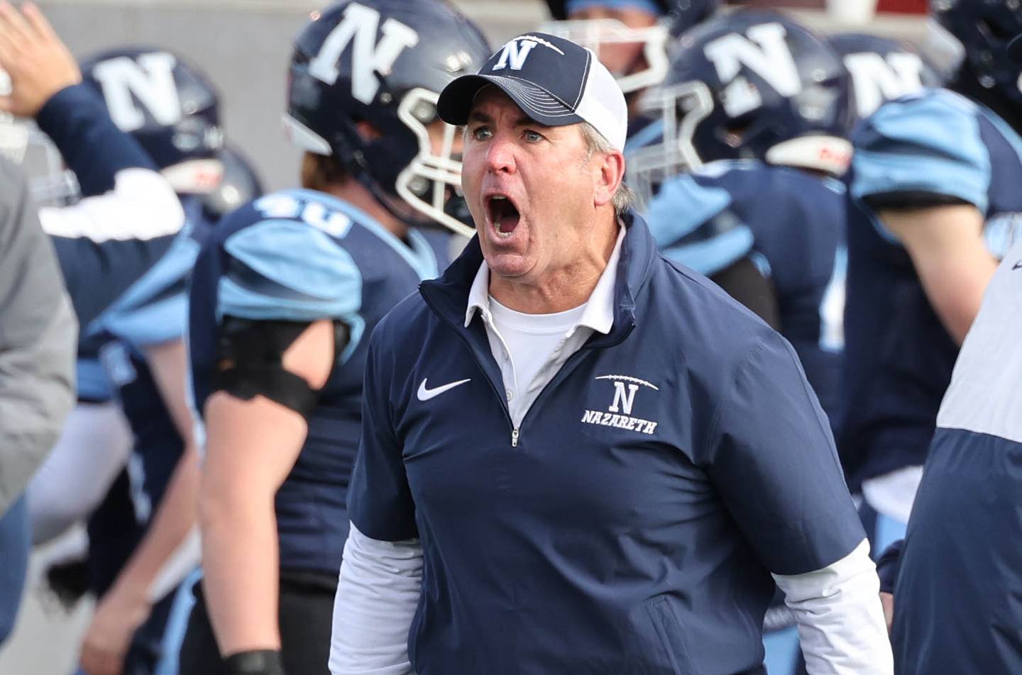 Nazareth Head Coach Tim Racki celebrates his team stopping Joliet Catholic on a 4th down near the goal line Saturday, Nov. 25, 2023, during their IHSA Class 5A state championship game in Hancock Stadium at Illinois State University in Normal.