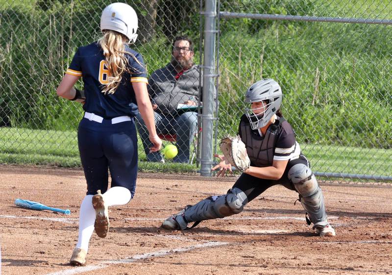 Sterling's Olivia Melcher scores on a close play as Sycamore's Kairi Lantz tries to corral the throw during their game Tuesday, May 14, 2024, at Sycamore High School.