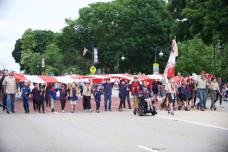 Boy Scouts caring a big American flag down the parade route at the St. Charles Memorial Day Parade on Monday, May 27,2024 in St. Charles.