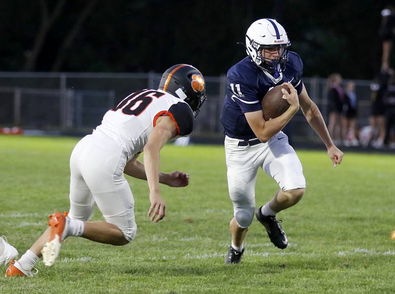 Cary-Grove's Peyton Seaburg tries to run away from the pursuit of Crystal Lake Central's Nicholas Zuehlke during a Fox Valley Conference football game on Friday, Sept. 6, 2024, at Cary-Grove High School in Cary.