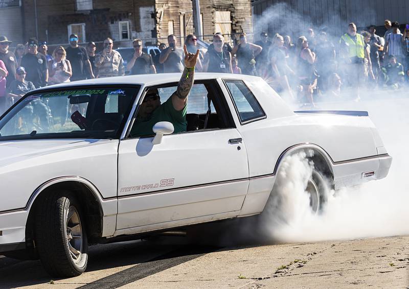 Horns up as a driver tears down the strip Monday, June 10, 2024 in Rock Falls. After the contest, many visitors took to the downtown to enjoy food, music and local businesses.