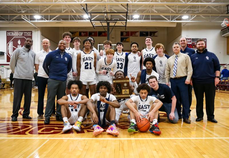 Oswego East poses with the Class 4A Lockport Regional final game plaque after defeating Aurora.  Feb 24, 2023.