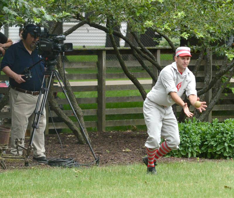 Ganymede Mike "Mouth" Benesh fields a hlt as the ceterfield cameraman zeroes in on the play during a vintage base ball game against the DuPage Plowboys at the John Deere Historic Site in Grand Detour on Saturday, June 8, 2024.