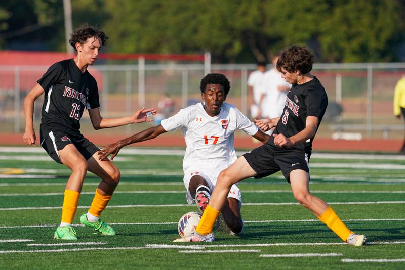 Oswego’s Thomas Marcoux (17) challenges Yorkville's Alex Arriaga (13) and Jack Gleason (6) for the ball during a soccer match at Yorkville High School on Tuesday, Sep 17, 2024.