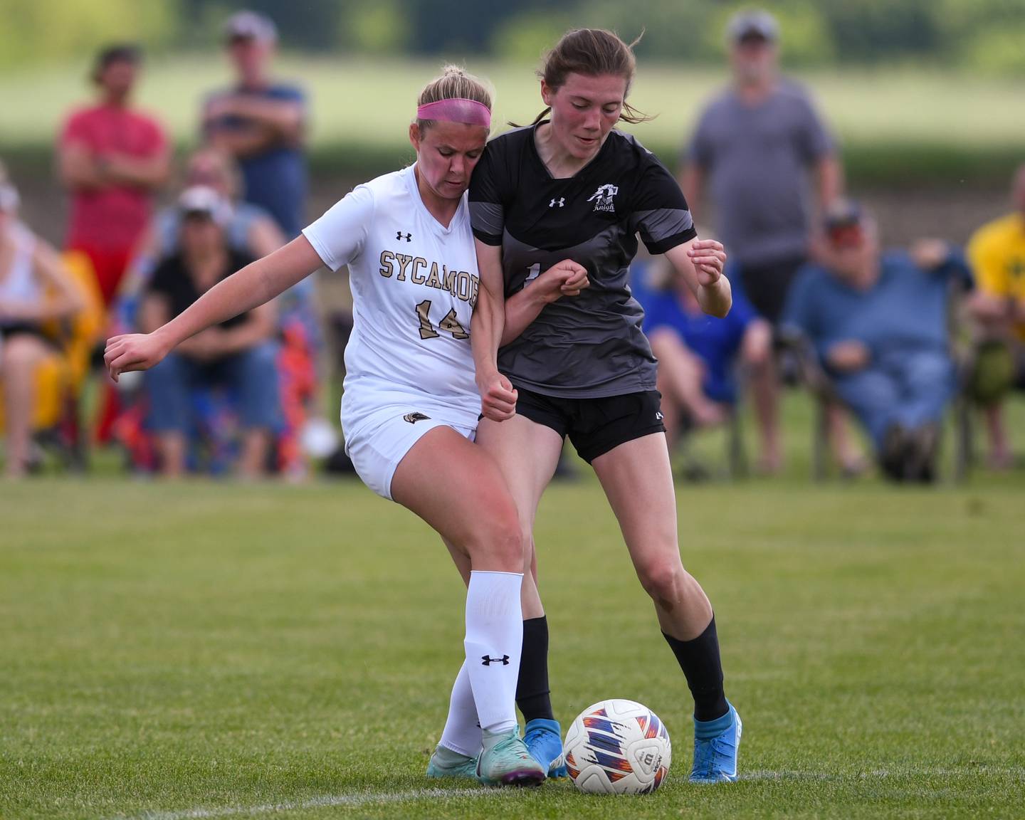 Sycamore's Peyton Wright (14) and Kaneland's Erin Doucette (14) collide while going after the ball during the regional title game held on Saturday May 18, 2024, at Kaneland High School.
