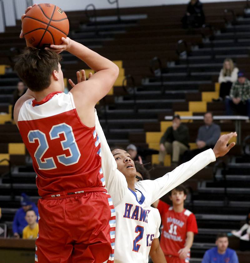 Hoffman Estates’ Jacob Atkins-Mirich tries to block the shot of Marian Central's Cale McThenia during a Hinkle Holiday Classic basketball game Tuesday, Dec. 27, 2022, at Jacobs High School in Algonquin.