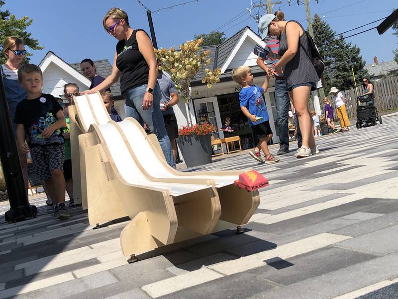 One of the toy cars takes flight at the end of the racetrack on Saturday, Aug. 24, 2024, outside Marvin's Toy Store at McHenry's Riverwalk Shoppes.