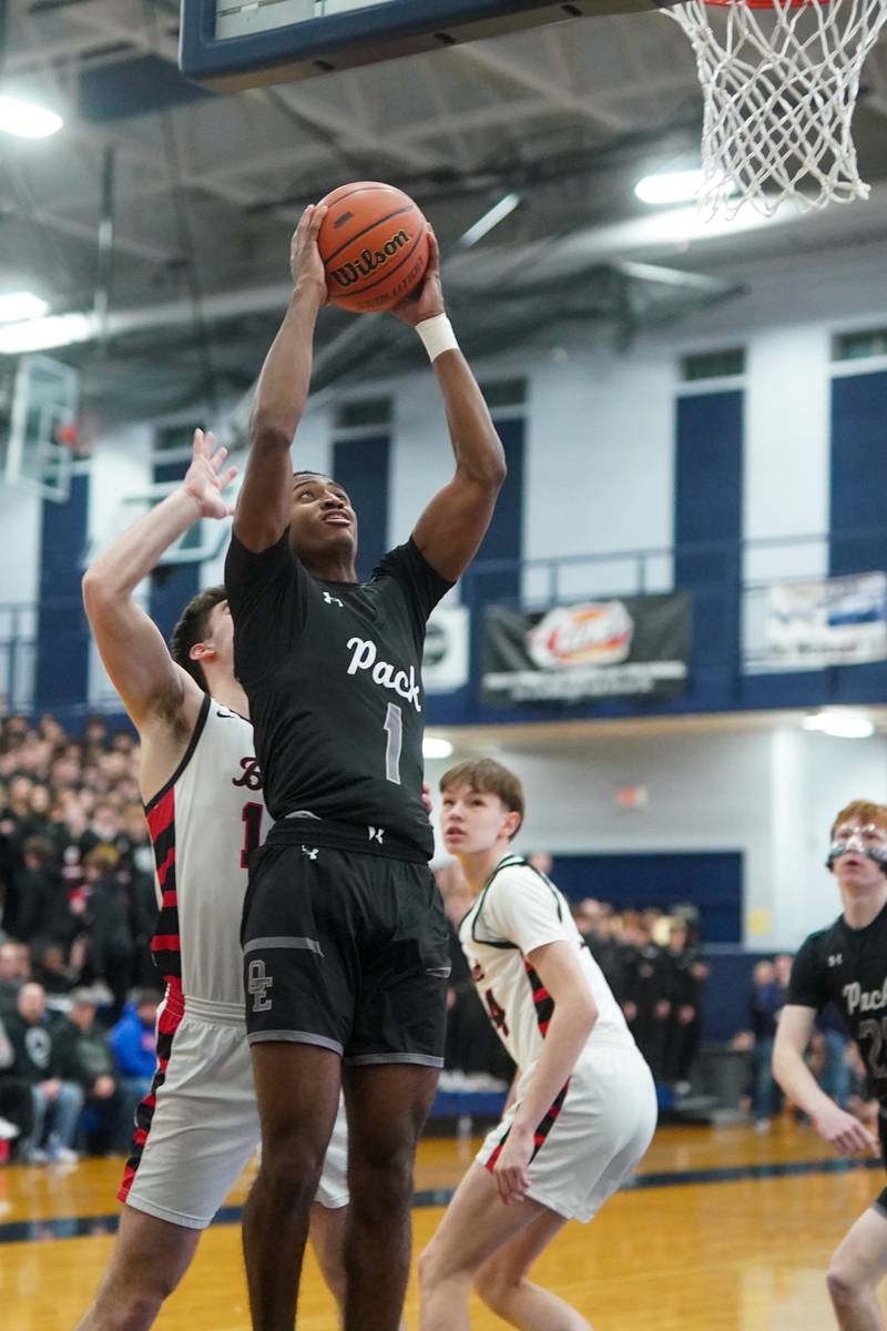 Oswego East's Andrew Wiggins (1) shoots the ball in the post against Benet’s Parker Sulaver (14) during a Class 4A Oswego East regional final basketball game at Oswego East High School on Friday, Feb 23, 2024.