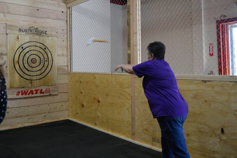 Chris Williams, of Oregon, throws an ax during the grand opening of Rustic Ridge Axe Throwing on May 28. The business is located at 117 N. 4th St., Oregon, and is affiliated with the World Axe Throwing League.