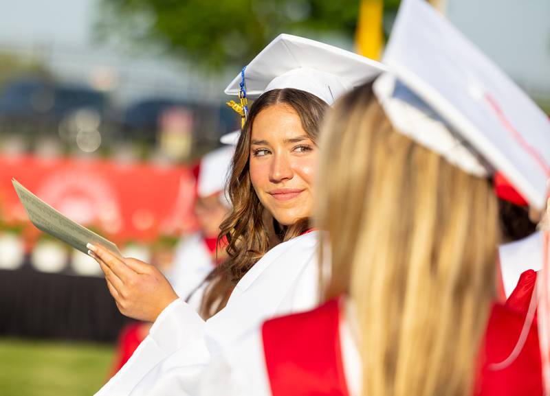 Dagny Tombaugh turns around to clap for attending family members during Benet Academy’s Class of 2024 graduation ceremony, Thursday, May 23, 2024.