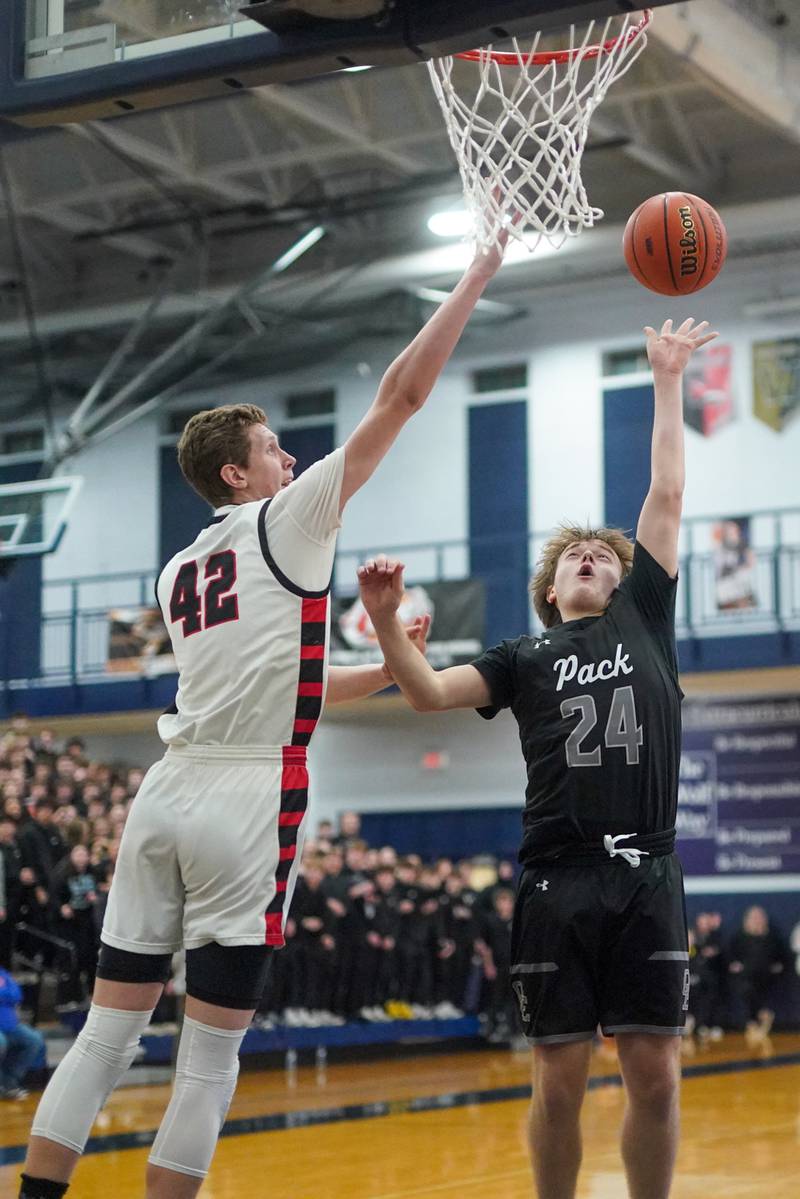 Oswego East's Lukas Adolfs (24) shoots a floater over Benet’s Colin Stack (42) during a Class 4A Oswego East regional final basketball game at Oswego East High School on Friday, Feb 23, 2024.