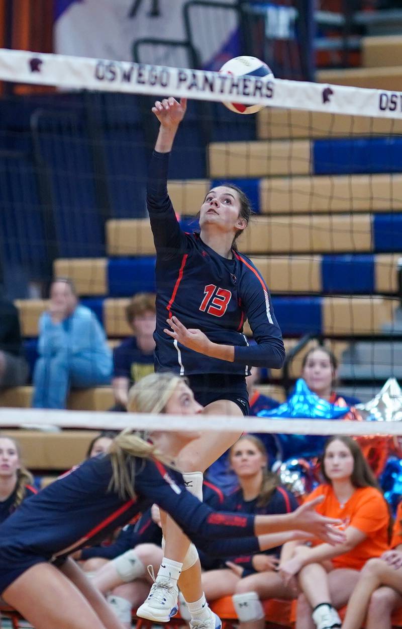 Oswego’s Sidney Hamaker (13) goes up for a kill against Romeoville during a volleyball game at Oswego High School on Tuesday, Oct. 17, 2023.